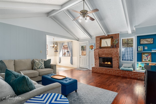 living room with a textured ceiling, a fireplace, and dark wood-type flooring