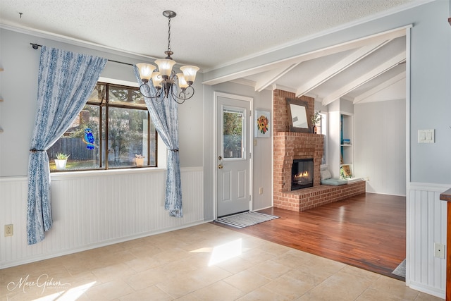 unfurnished dining area with a textured ceiling, light tile patterned flooring, vaulted ceiling with beams, and a chandelier