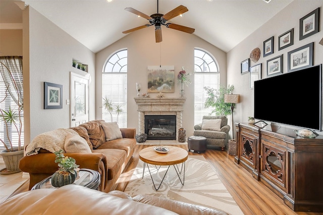 living room featuring ceiling fan, light wood-type flooring, and lofted ceiling