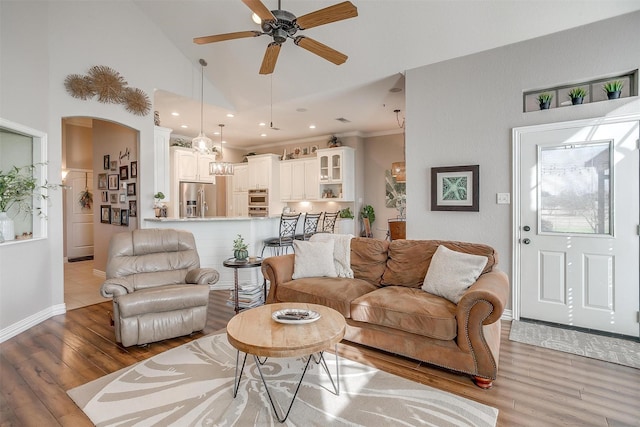 living room with ceiling fan, high vaulted ceiling, and wood-type flooring