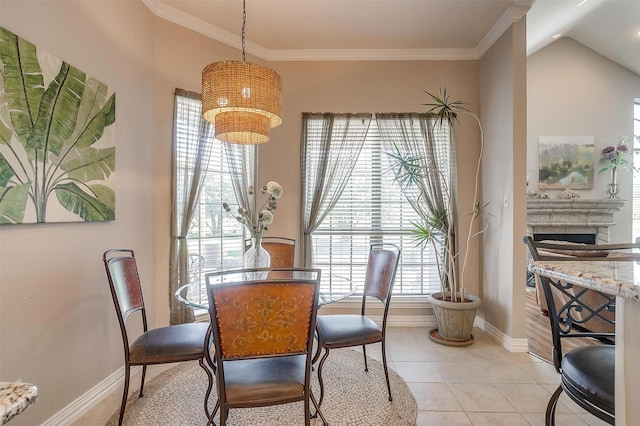 dining space featuring ornamental molding and light tile patterned flooring