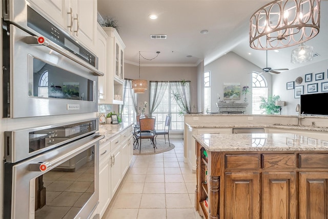 kitchen featuring ceiling fan with notable chandelier, white cabinetry, and light stone counters