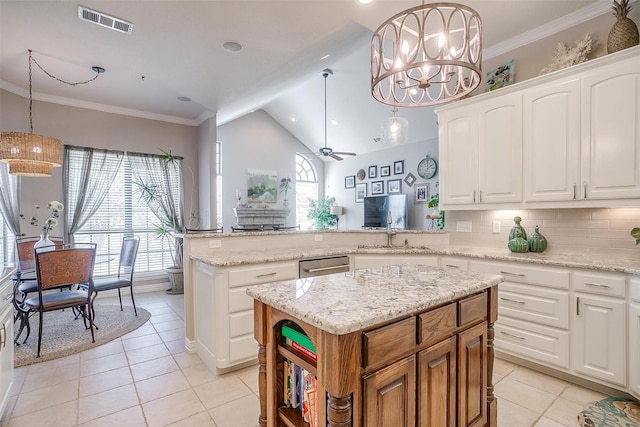 kitchen with a kitchen island, hanging light fixtures, and white cabinetry