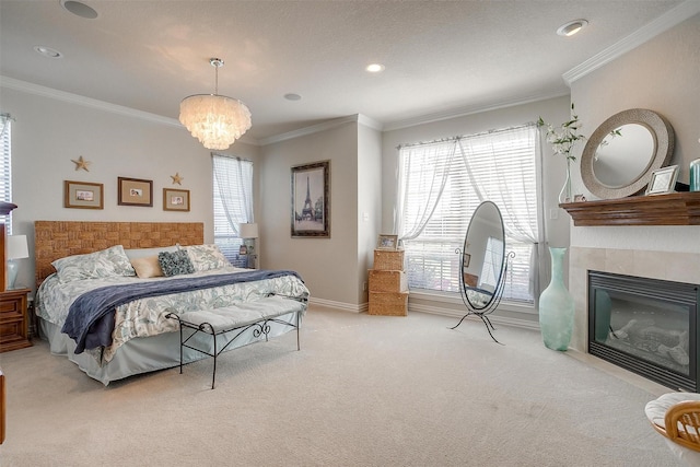 carpeted bedroom with a notable chandelier, ornamental molding, and a tiled fireplace