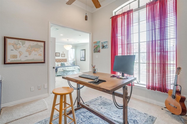 home office featuring carpet floors, ceiling fan, and crown molding