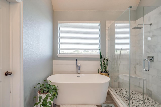 bathroom featuring shower with separate bathtub