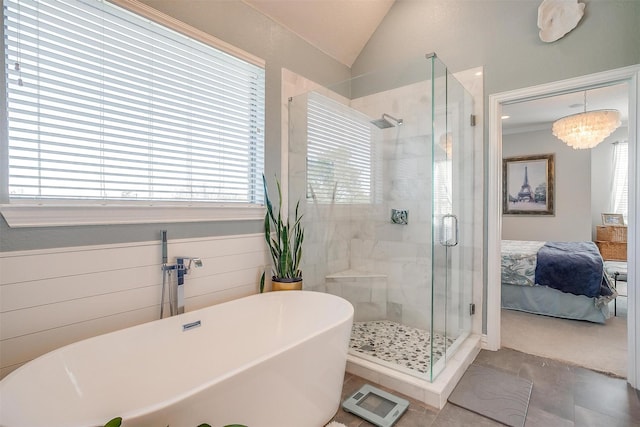 bathroom featuring lofted ceiling, plus walk in shower, and a notable chandelier