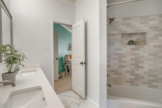 bathroom featuring tiled shower / bath combo, crown molding, and vanity