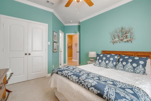 carpeted bedroom with ceiling fan, crown molding, and a closet