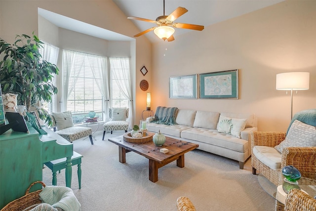 living room with lofted ceiling, ceiling fan, and light carpet