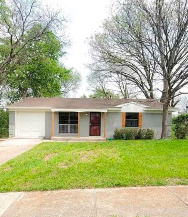 single story home featuring a front lawn and a garage