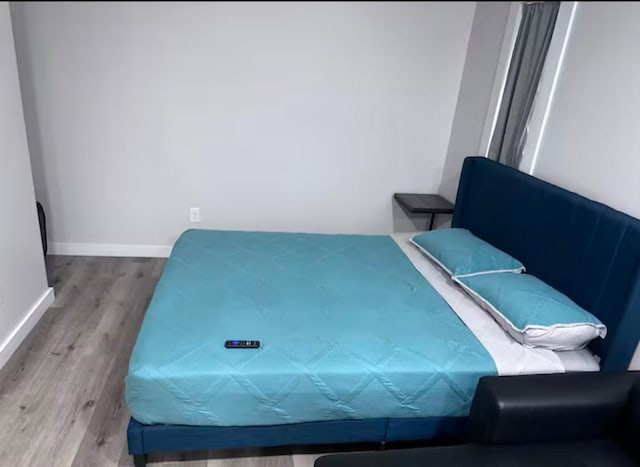 bedroom with wood-type flooring