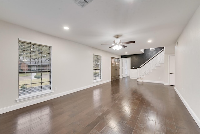 unfurnished living room with ceiling fan and dark hardwood / wood-style flooring