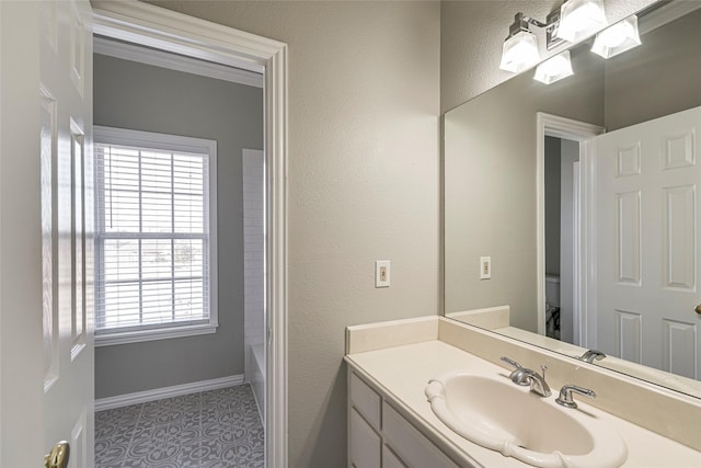 full bathroom with toilet, vanity, tile patterned floors, and a wealth of natural light