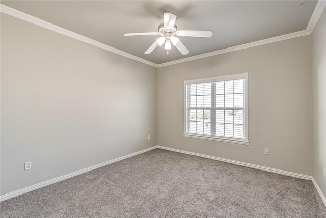 carpeted empty room featuring ceiling fan and crown molding