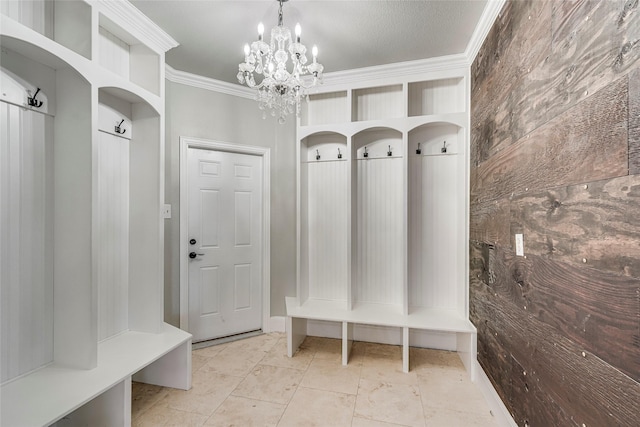 mudroom with crown molding and a chandelier