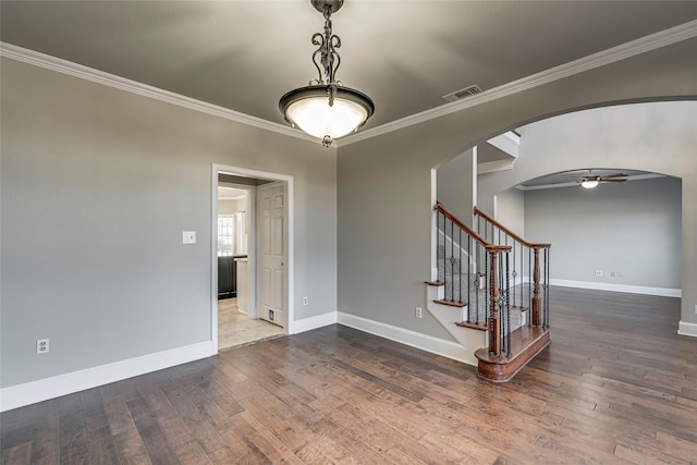 unfurnished room featuring ceiling fan, crown molding, and hardwood / wood-style flooring