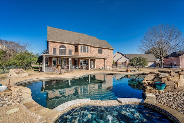 view of swimming pool featuring a patio and an in ground hot tub