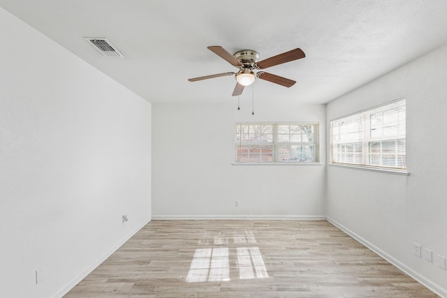 empty room featuring ceiling fan and light hardwood / wood-style floors