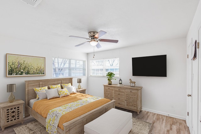 bedroom featuring ceiling fan and light hardwood / wood-style flooring