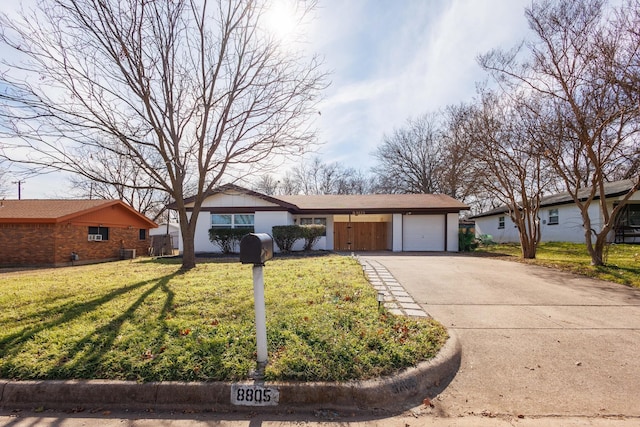 single story home featuring a garage and a front yard