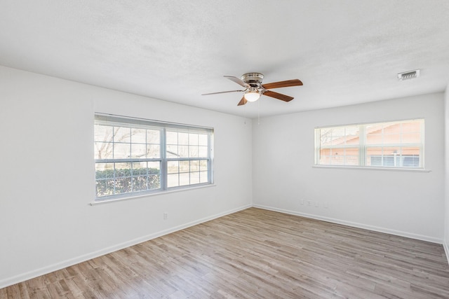 spare room with ceiling fan and light hardwood / wood-style floors