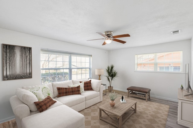 living room with ceiling fan and light hardwood / wood-style flooring