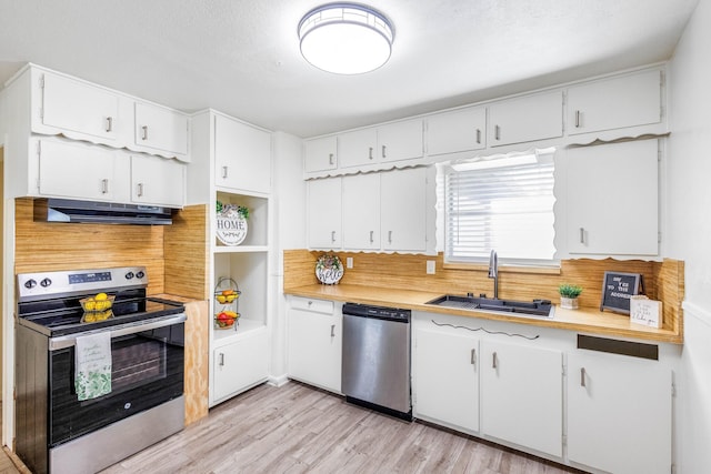 kitchen featuring sink, appliances with stainless steel finishes, light hardwood / wood-style floors, a textured ceiling, and white cabinets