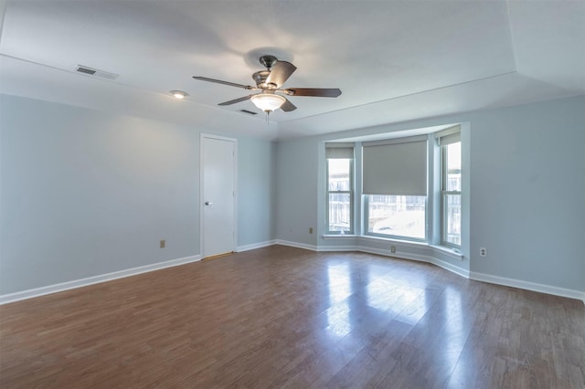 empty room featuring ceiling fan and dark wood-type flooring