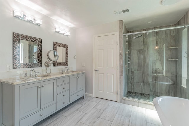 bathroom with independent shower and bath and vanity