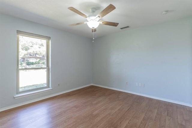 empty room featuring ceiling fan and hardwood / wood-style floors