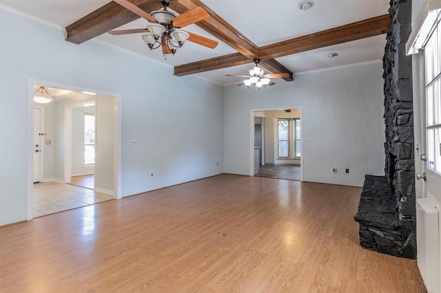 unfurnished living room with beamed ceiling, ceiling fan, light hardwood / wood-style floors, radiator heating unit, and coffered ceiling