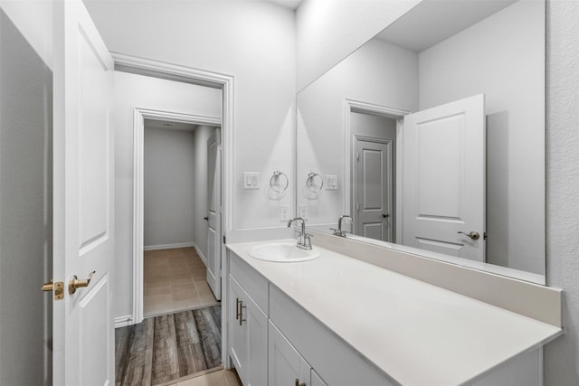 bathroom with vanity and hardwood / wood-style flooring