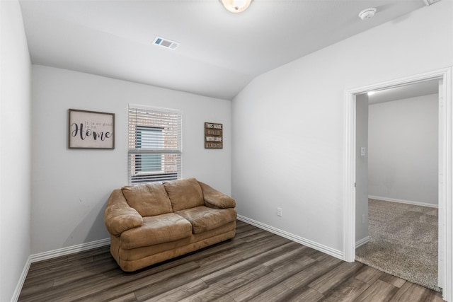 sitting room with lofted ceiling and dark hardwood / wood-style flooring