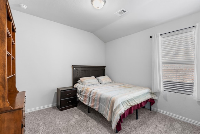 carpeted bedroom with vaulted ceiling