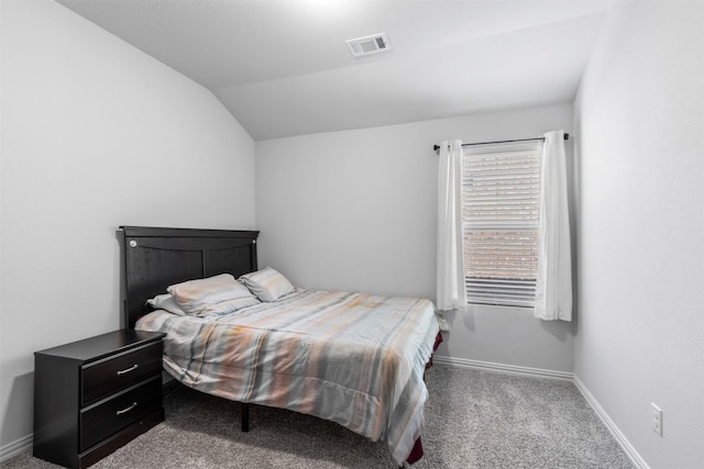 carpeted bedroom with lofted ceiling