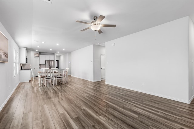 unfurnished dining area featuring ceiling fan and wood-type flooring