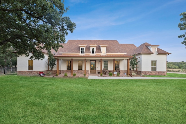 view of front of house featuring covered porch and a front lawn