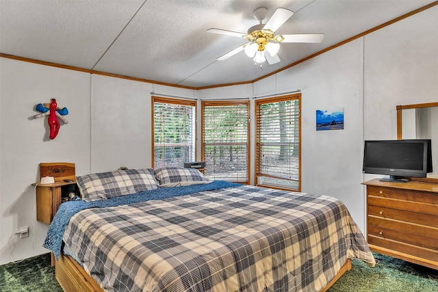 bedroom with a textured ceiling, lofted ceiling, ceiling fan, ornamental molding, and dark colored carpet