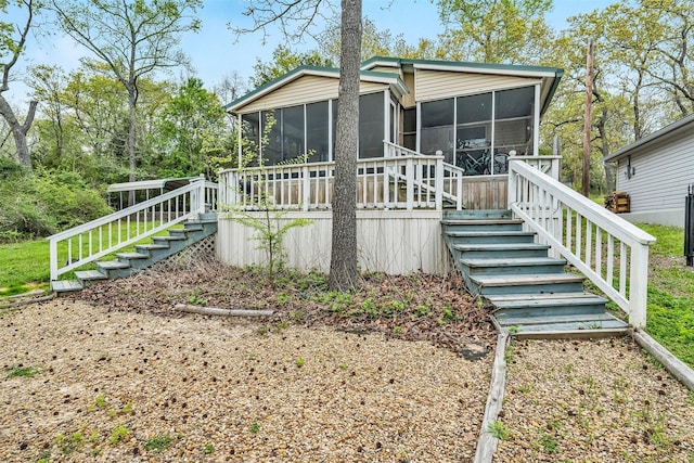 back of property featuring a sunroom