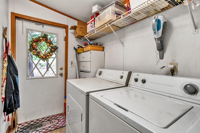 washroom with washing machine and dryer and a textured ceiling