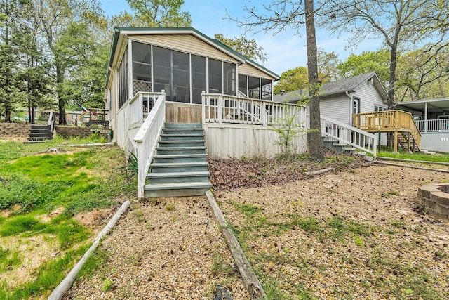 rear view of property with a sunroom