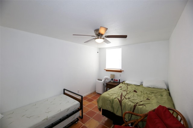 bedroom with a ceiling fan and tile patterned flooring