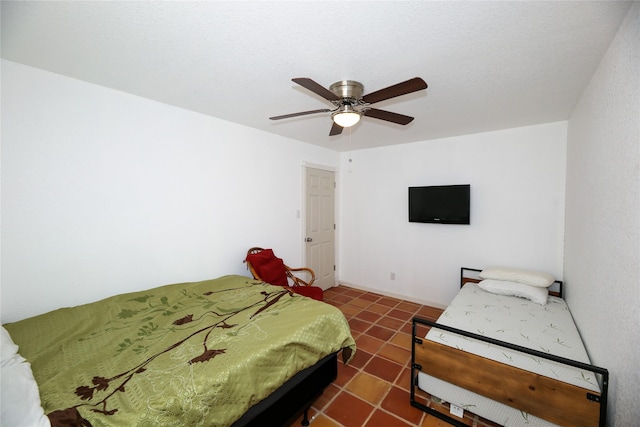 tiled bedroom featuring a ceiling fan