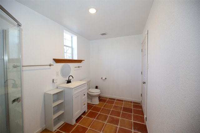 bathroom featuring vanity, visible vents, toilet, a stall shower, and baseboards