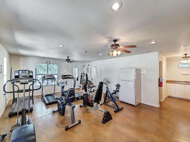 workout area with sink and a textured ceiling