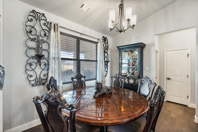 dining room with baseboards, visible vents, dark wood-style floors, vaulted ceiling, and a chandelier