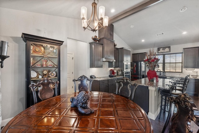 dining room featuring vaulted ceiling with beams, visible vents, and a notable chandelier