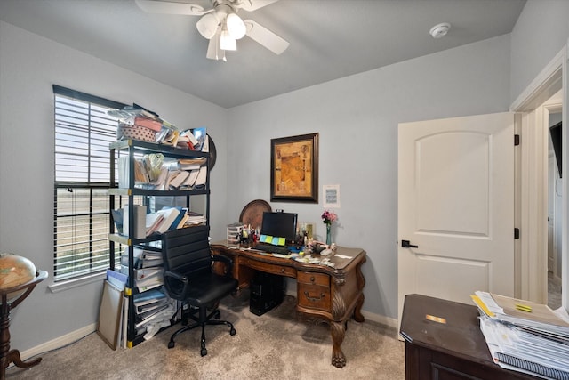 home office with a ceiling fan, carpet flooring, and baseboards