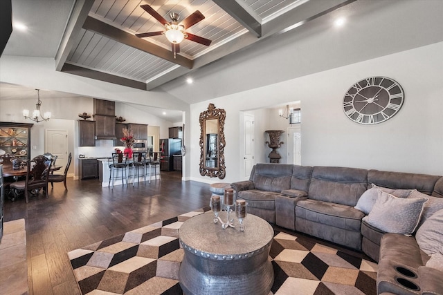 living room featuring dark wood-type flooring, vaulted ceiling with beams, baseboards, and ceiling fan with notable chandelier